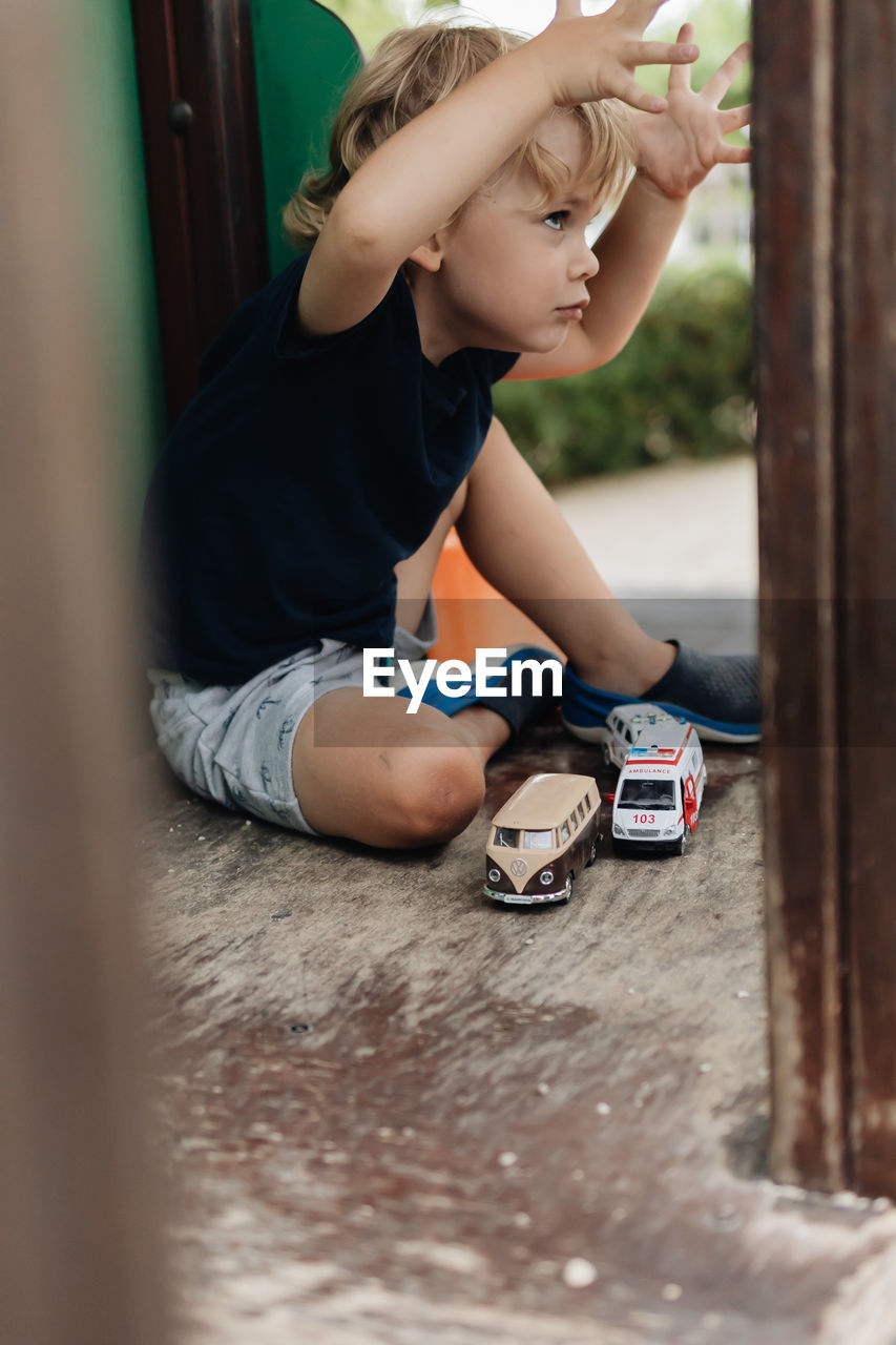 Boy playing with toy on floor