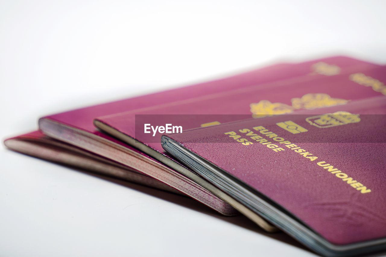 Close-up of passports against white background