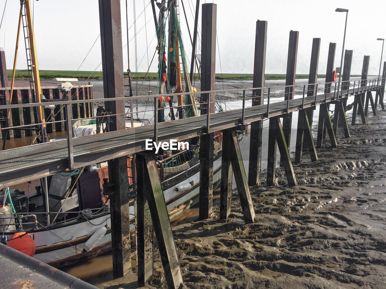 Wooden posts on beach against sky