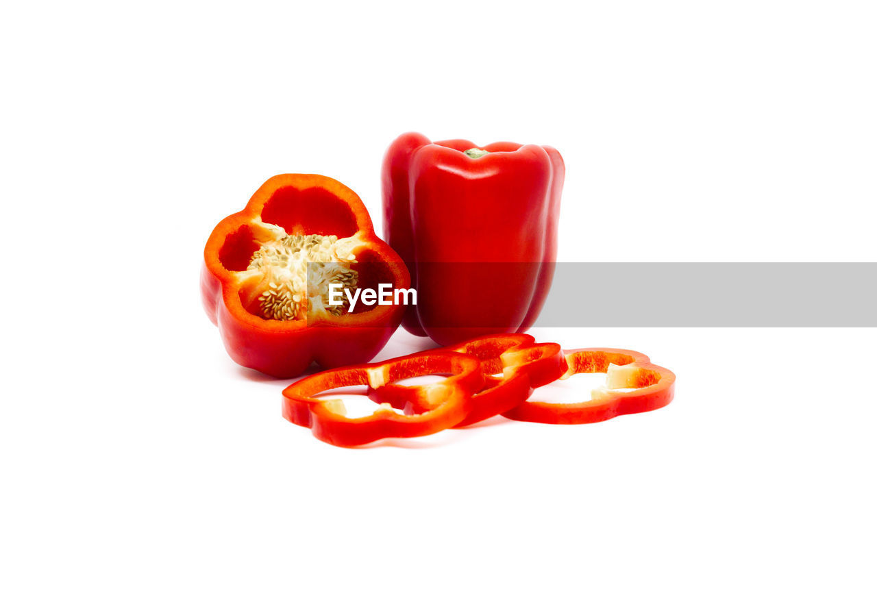 Close-up of re bell peppers against white background