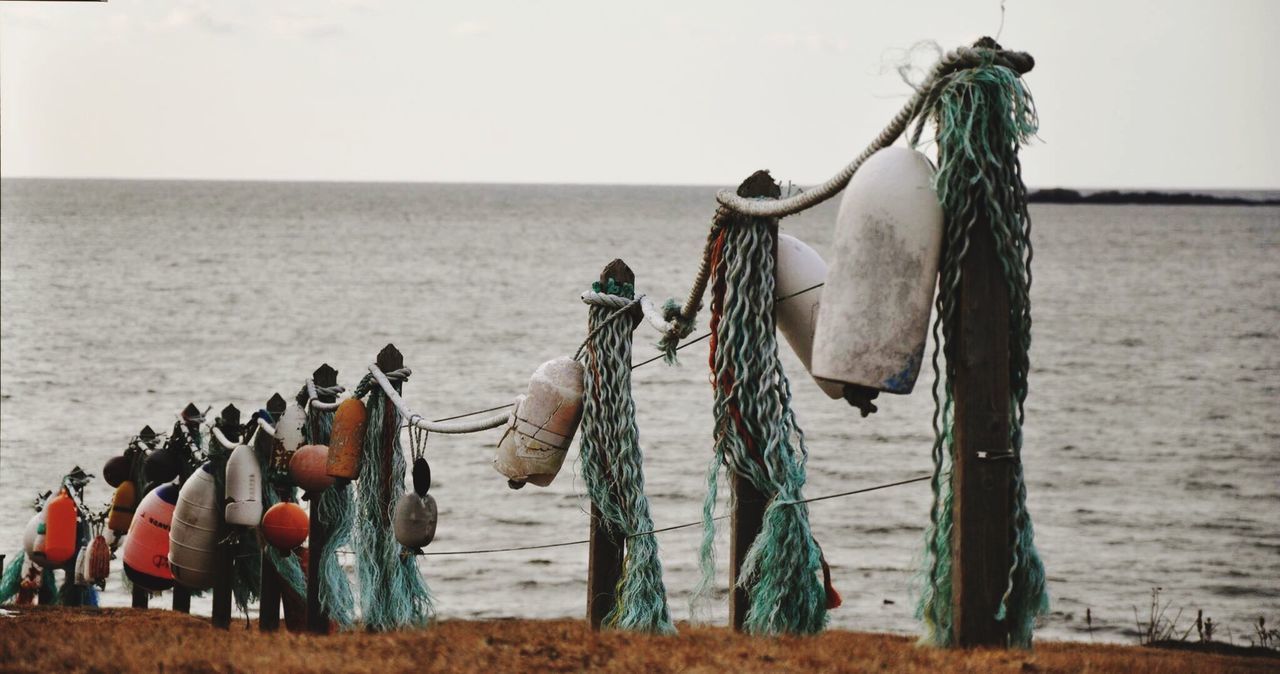CLOSE-UP OF FISHING NETS ON BEACH