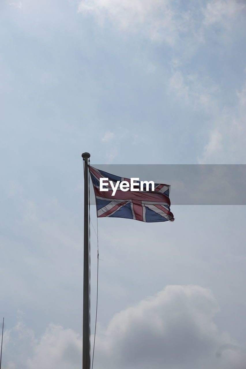 Low angle view of british flag against sky