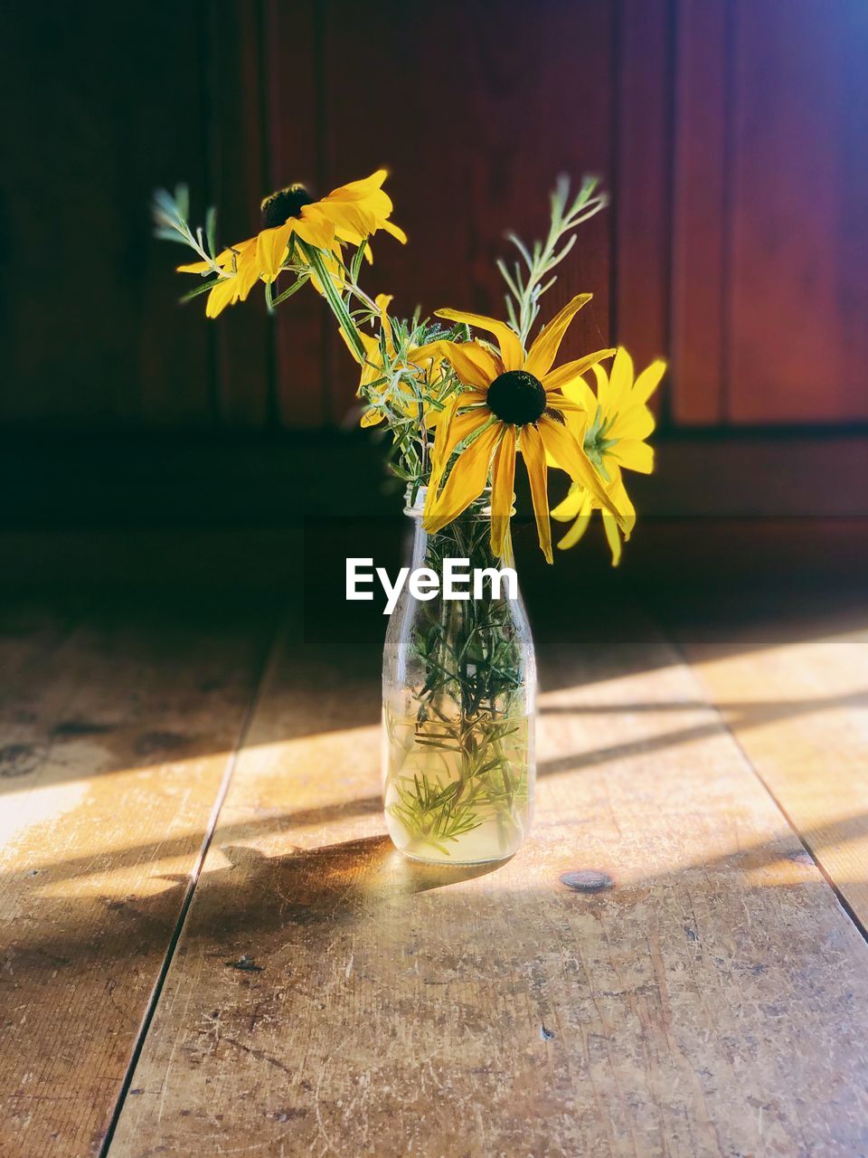 Close-up of yellow flower in vase on table