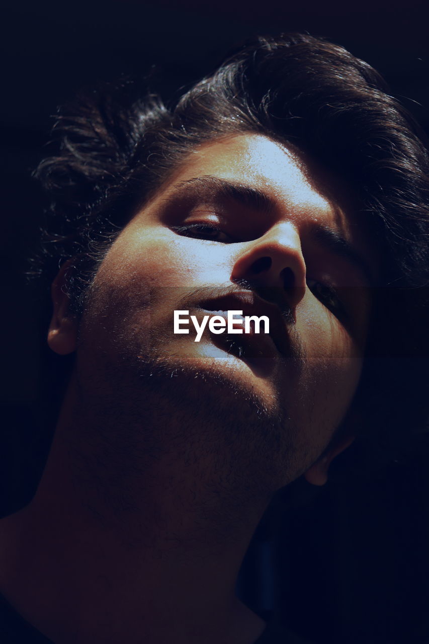 CLOSE-UP PORTRAIT OF YOUNG MAN WITH EYES