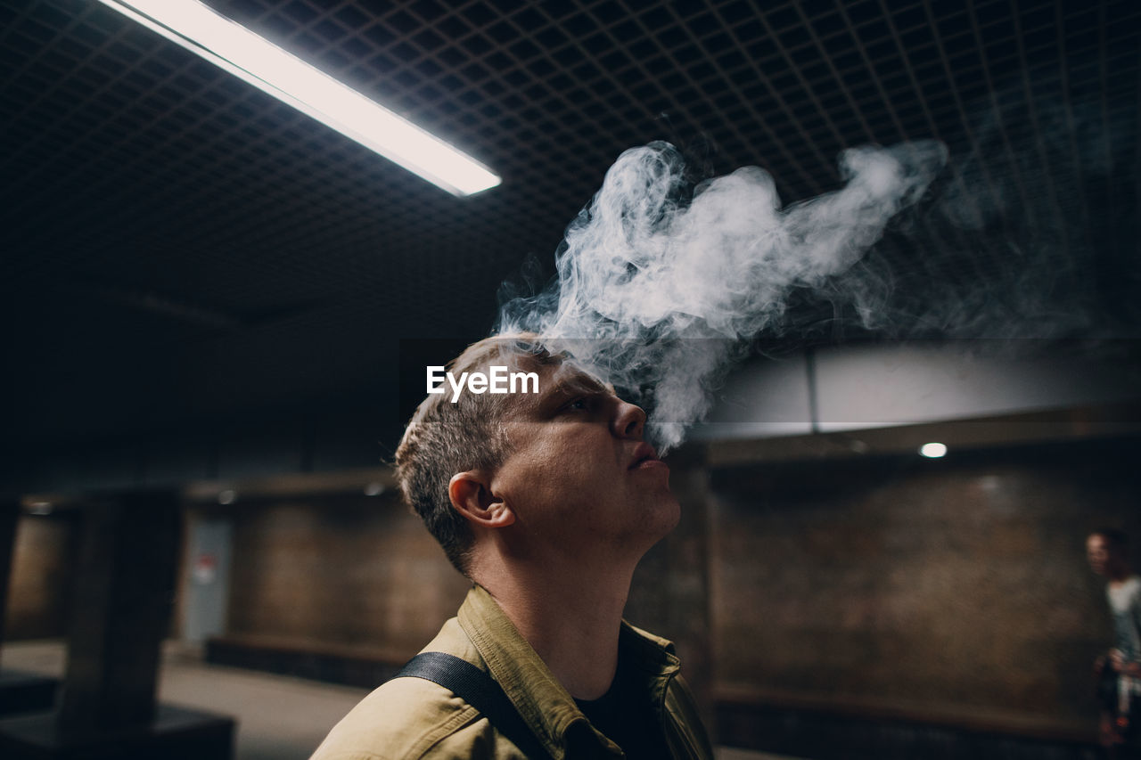 Portrait of man smoking cigarette