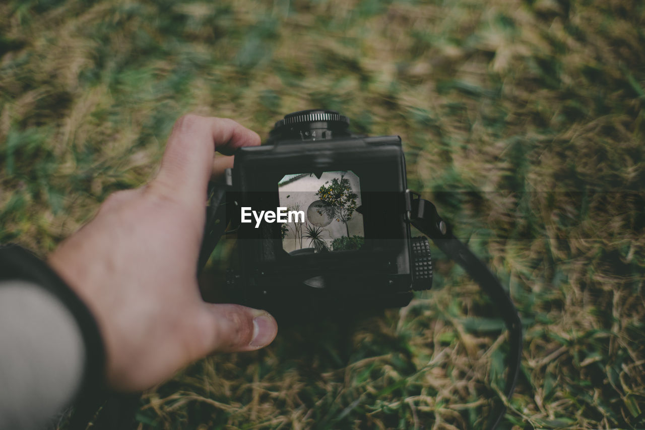 Person photographing through camera