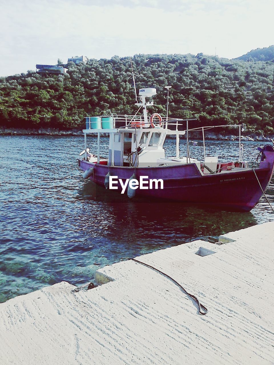 Boat moored at harbor