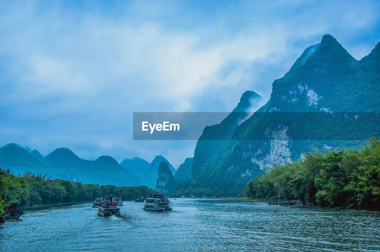 Scenic view of mountains against blue sky