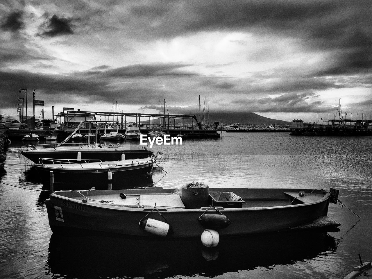 BOATS MOORED AT HARBOR