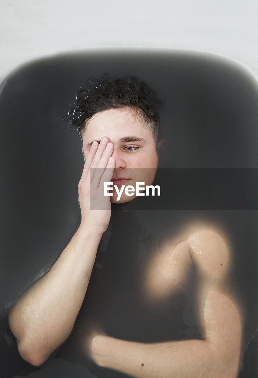 Close-up portrait of young man in water