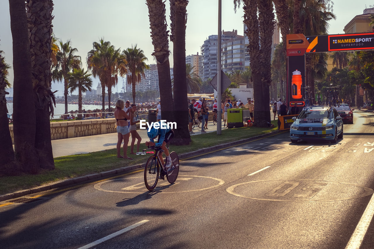 PEOPLE RIDING BICYCLE ON ROAD