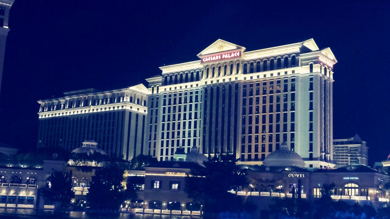 LOW ANGLE VIEW OF MODERN BUILDING AT NIGHT