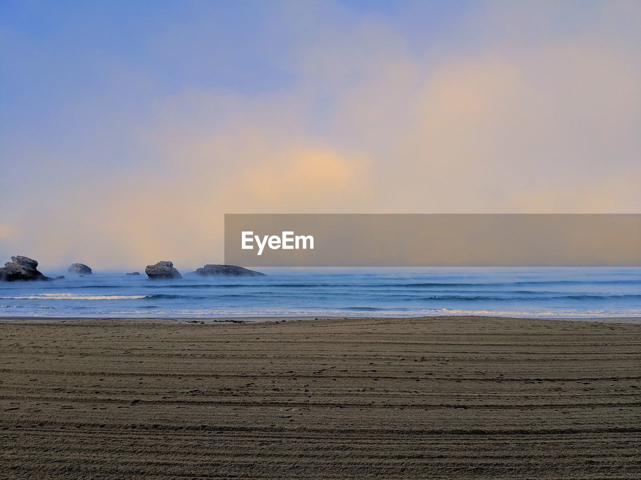 Scenic view of beach against sky during sunset