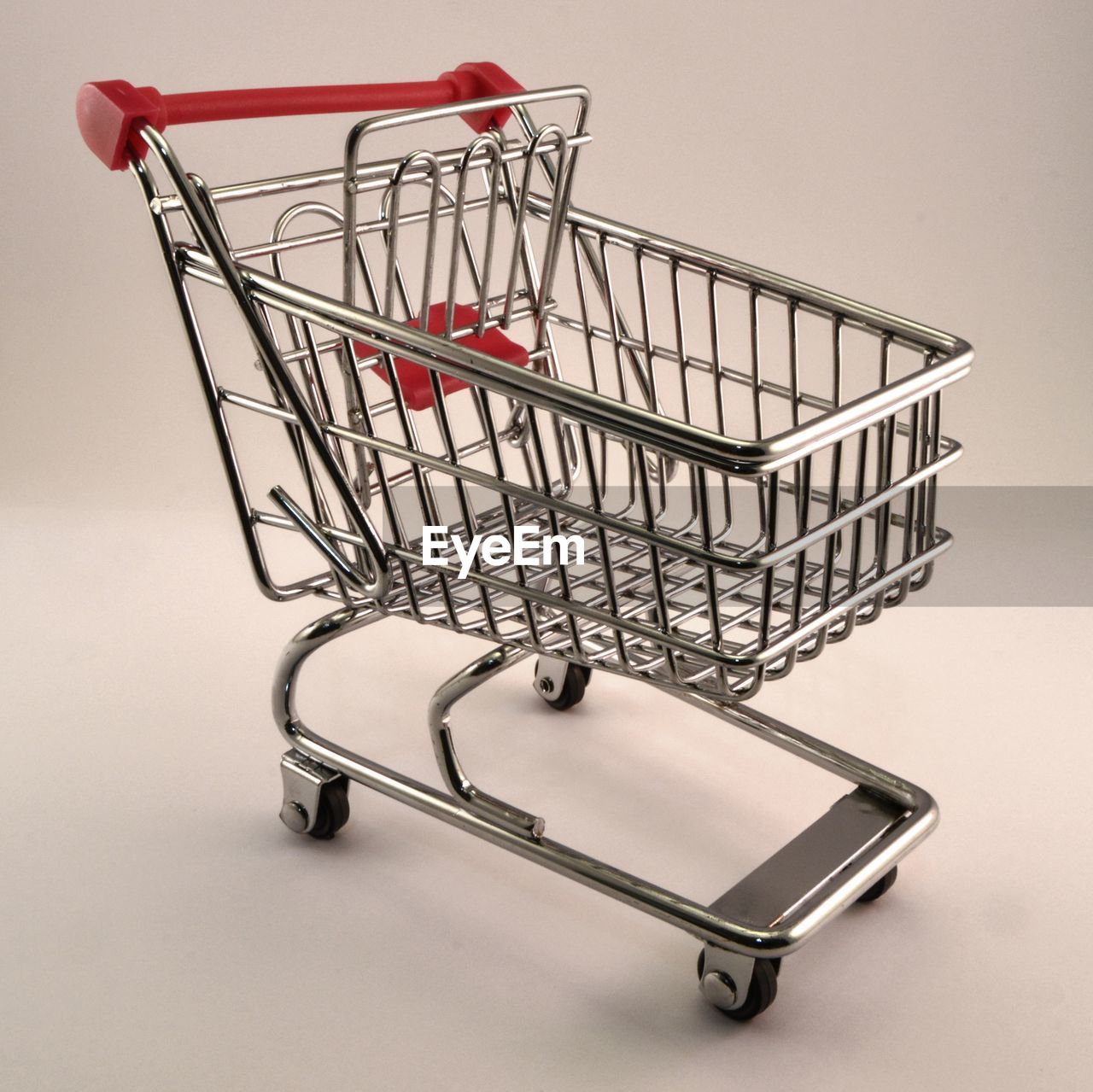 Empty shopping cart against white background