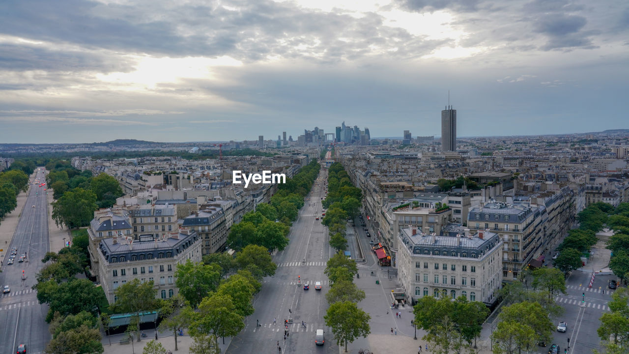 High angle view of city street against cloudy sky