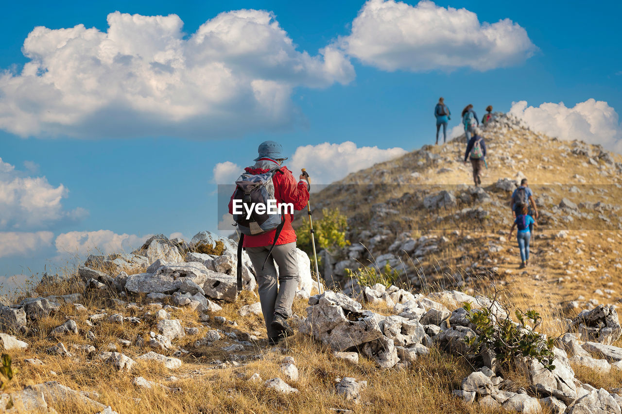 Group of hikers reach the top of the ridges of the mountains of pescasseroli, near the iorio refuge.