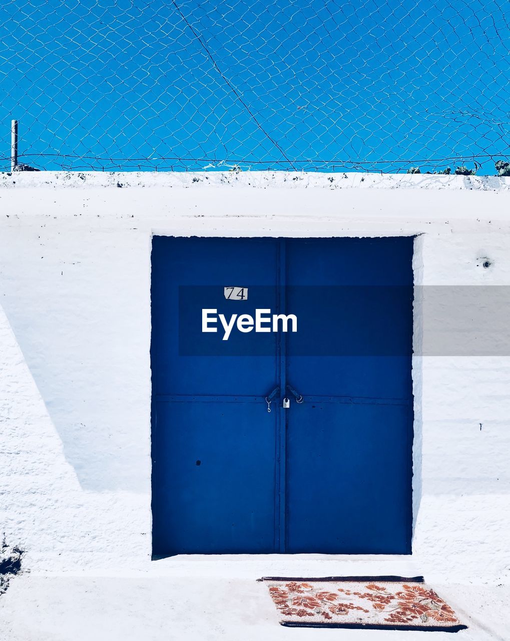 BLUE CLOSED DOOR OF BUILDING