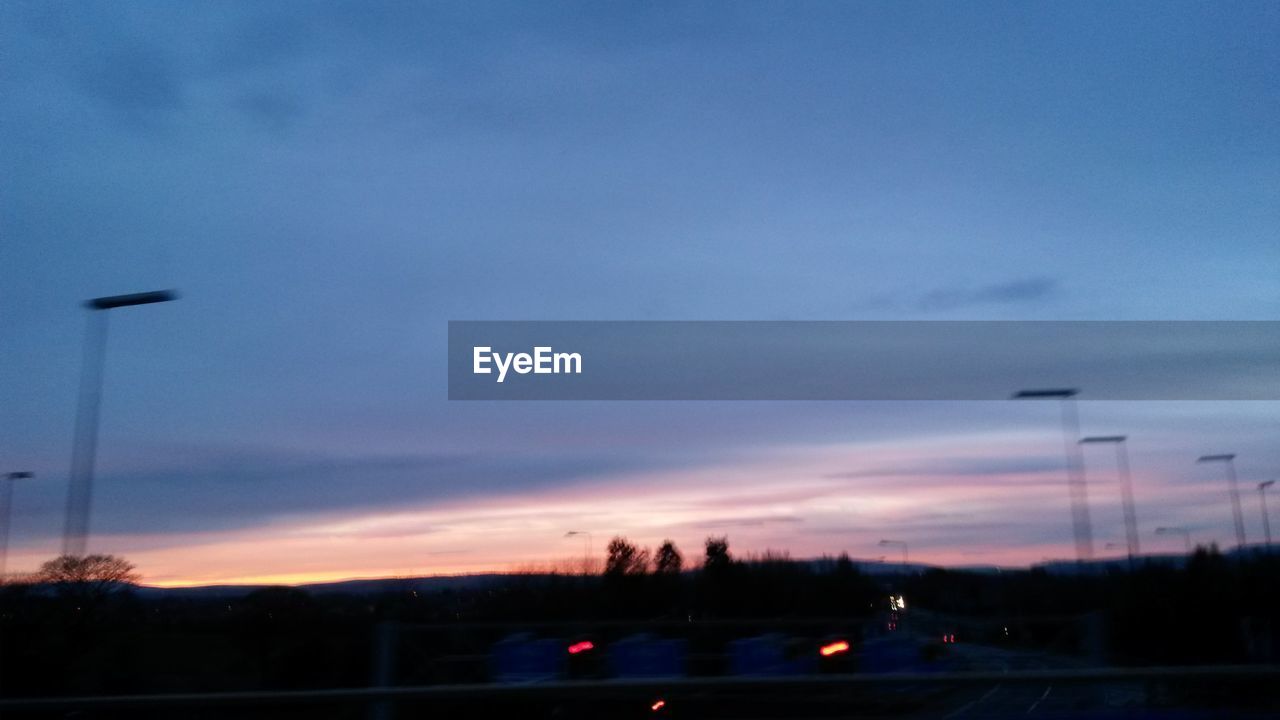 TRAFFIC ON ROAD AT SUNSET