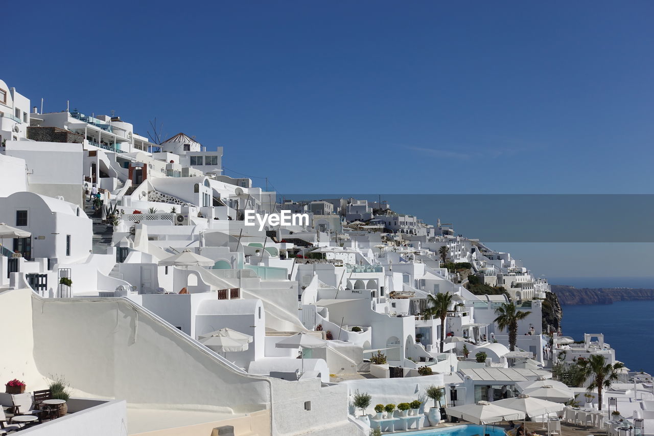 buildings in city against blue sky