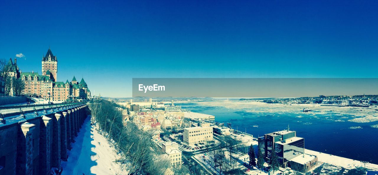 View of cityscape against clear blue sky