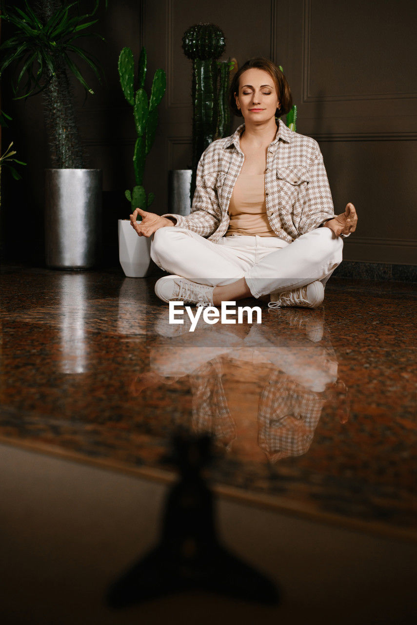 A close-up portrait of a woman holding a meditation statue, emphasizing calmness and mindfulness 