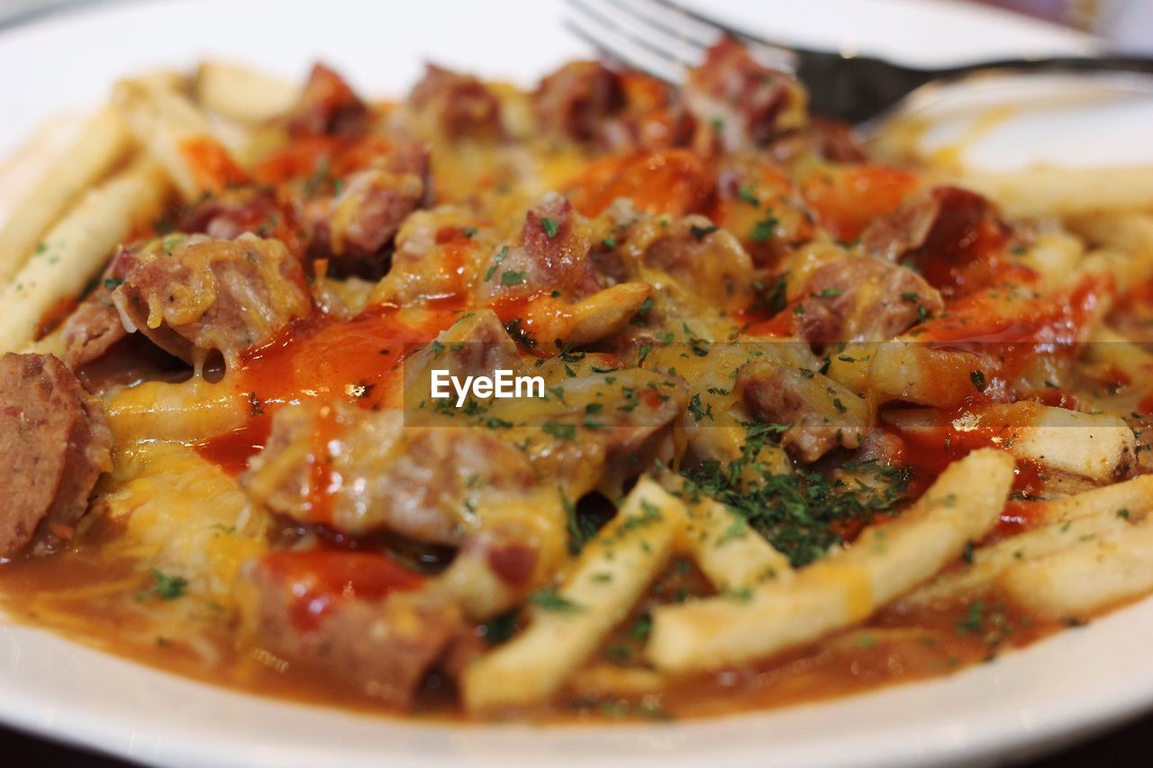 Close-up of cajun cheese fries served in plate
