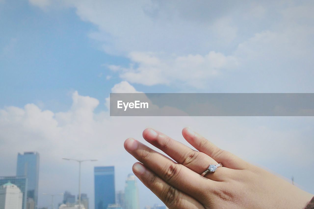 Cropped image of hand against sky