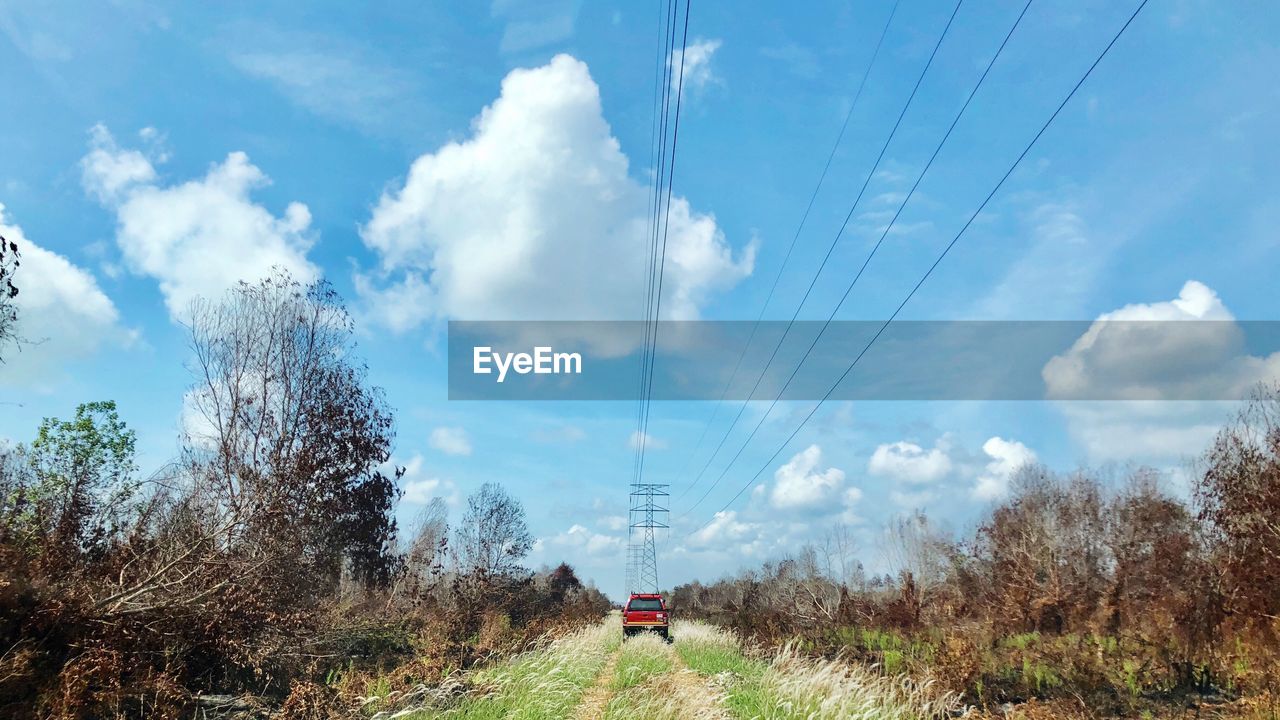 CARS ON ROAD AGAINST SKY