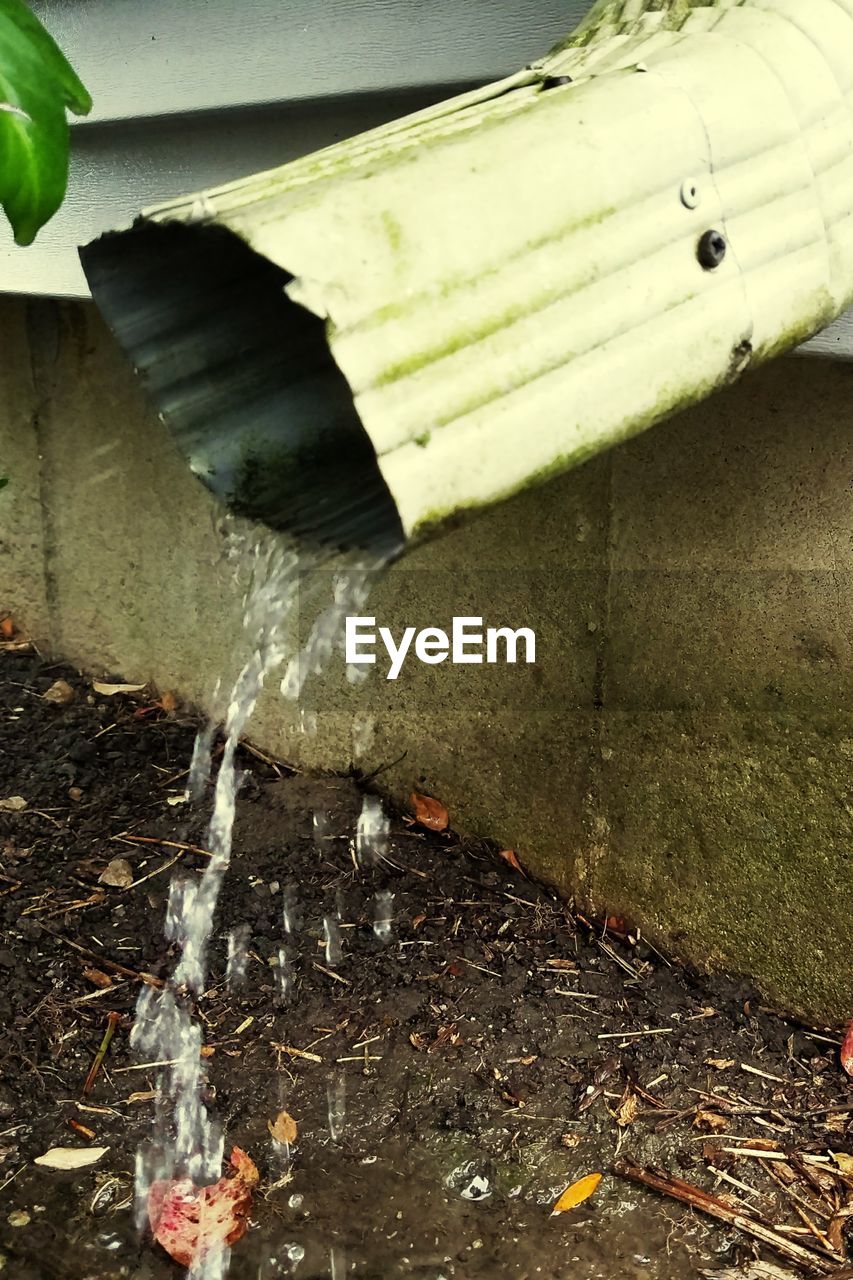 CLOSE-UP OF WATER PIPE IN CONTAINER