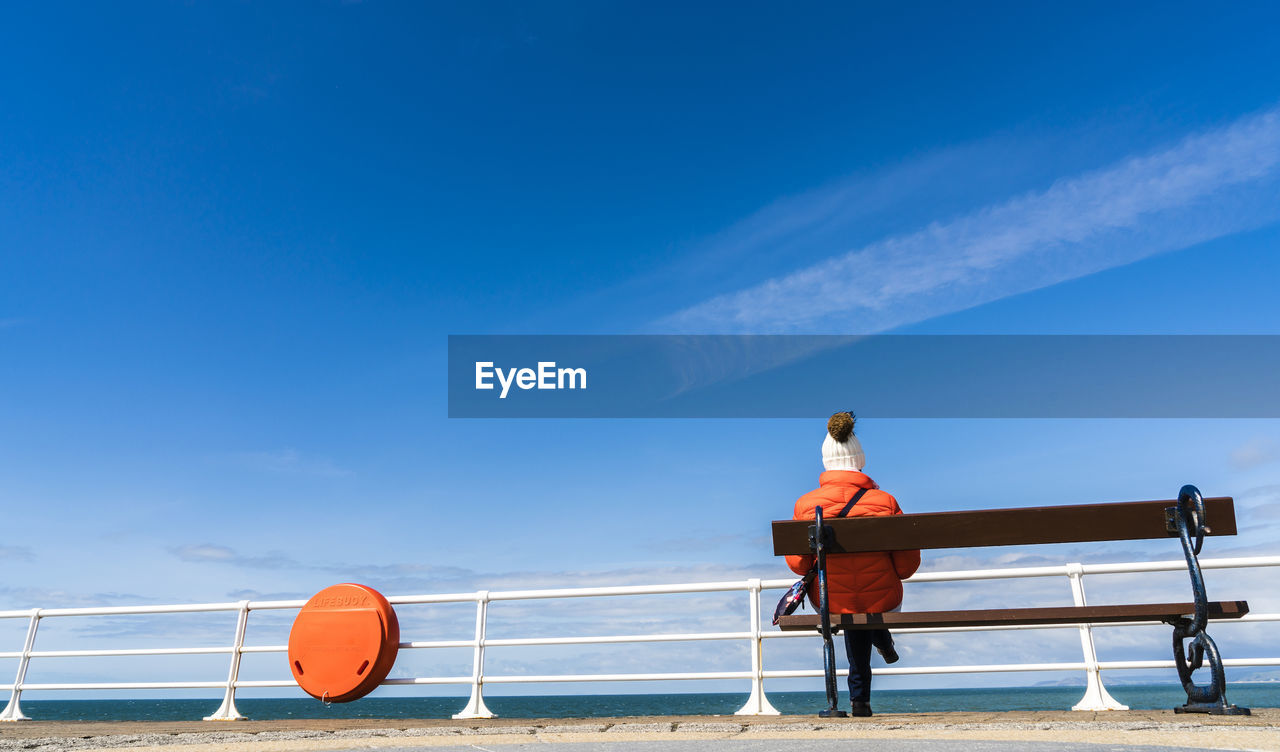 Woman on beach against sky