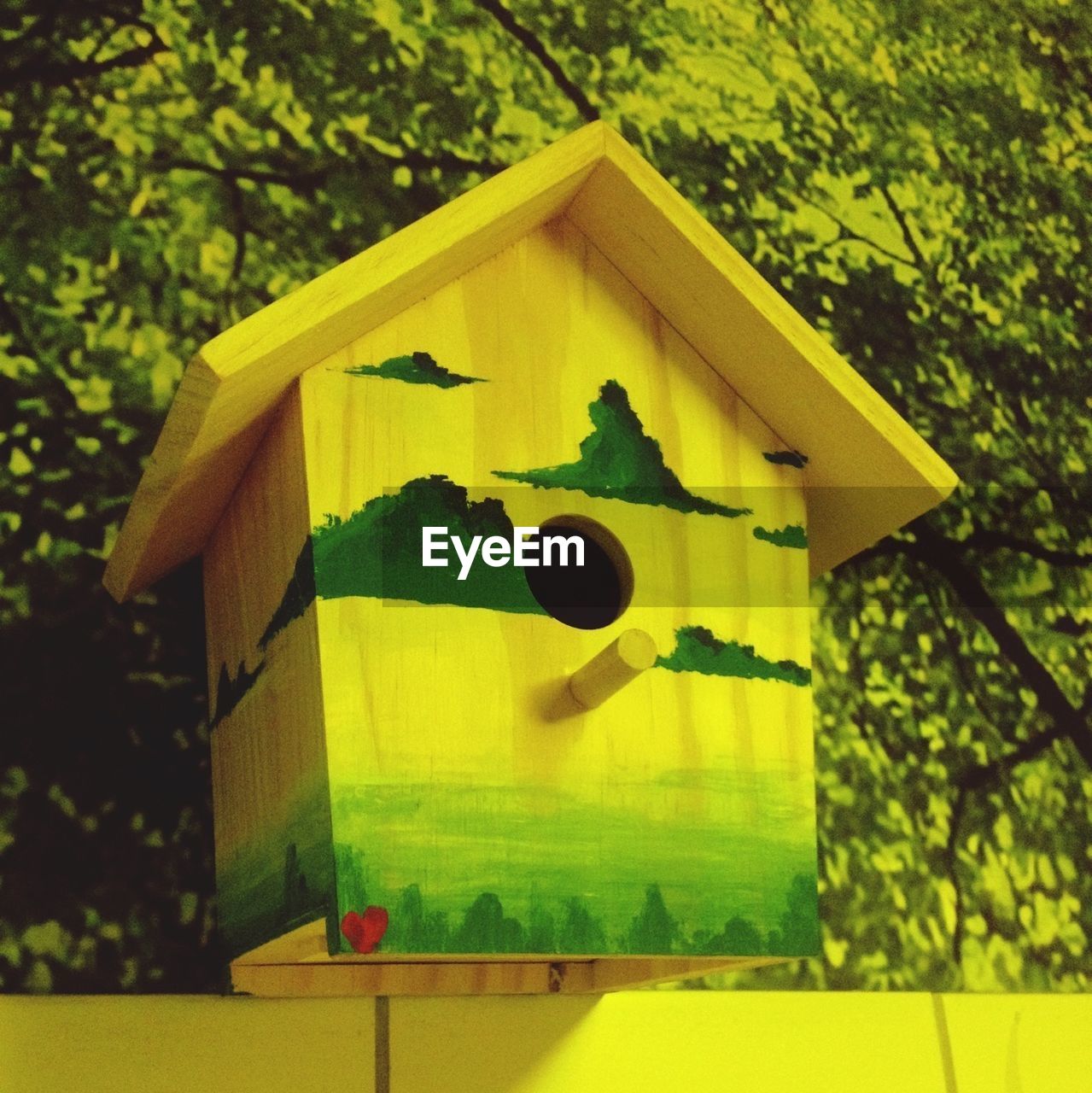 Yellow painted birdhouse
