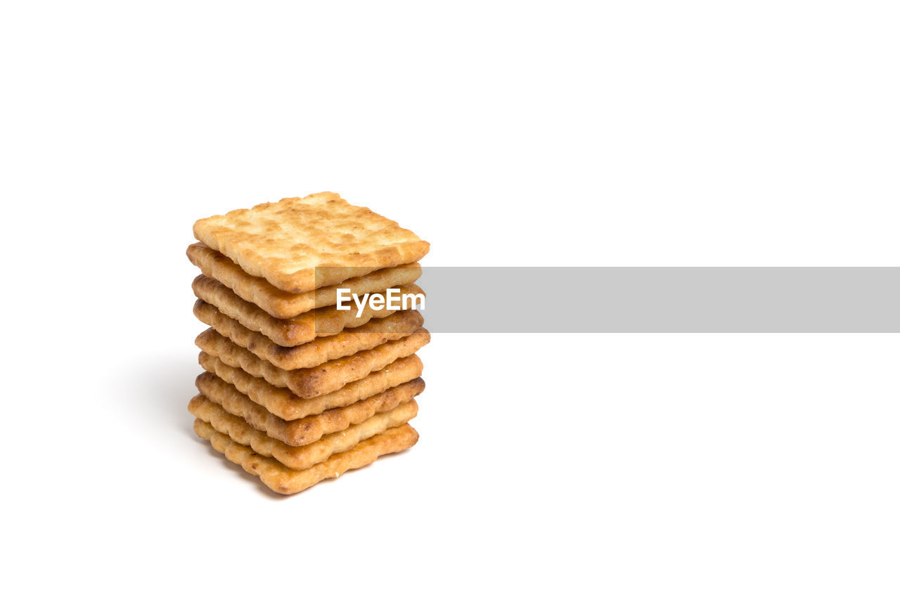 Stack of biscuits against white background