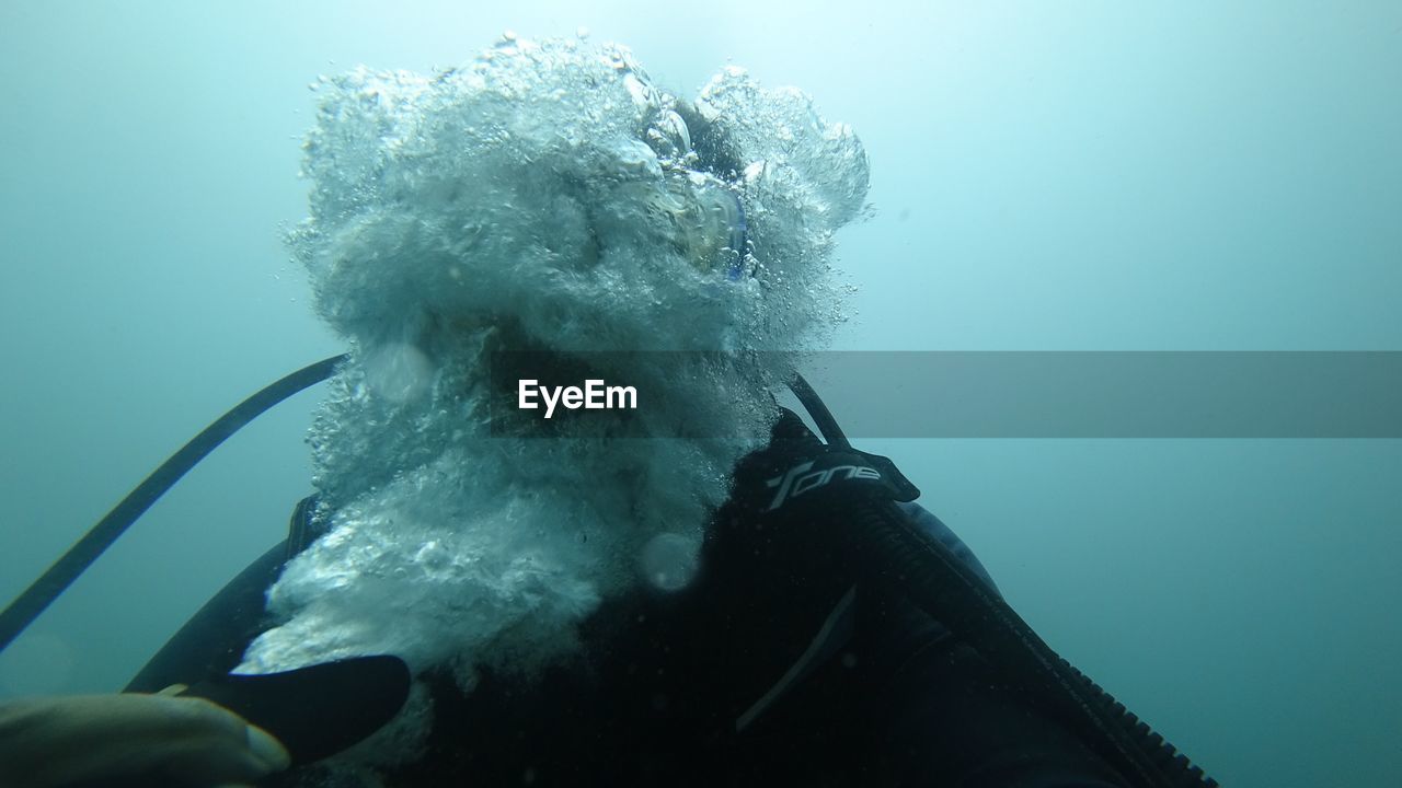 PERSON SWIMMING ON SEA