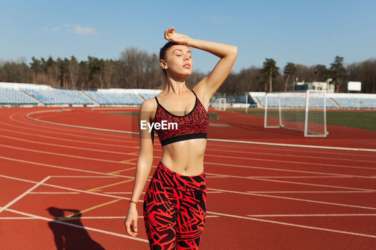 Mid adult woman standing on stadium