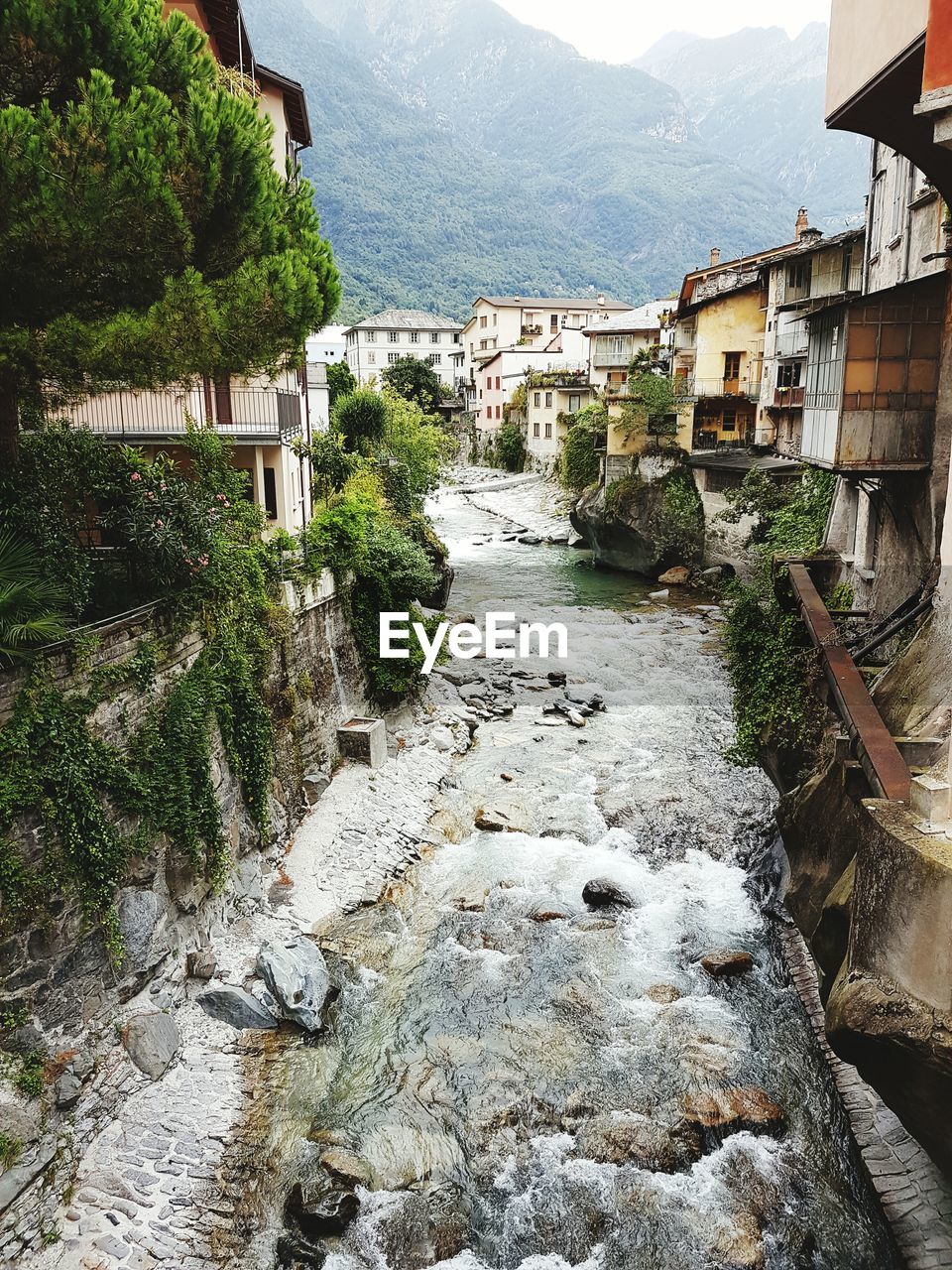 River by houses against sky