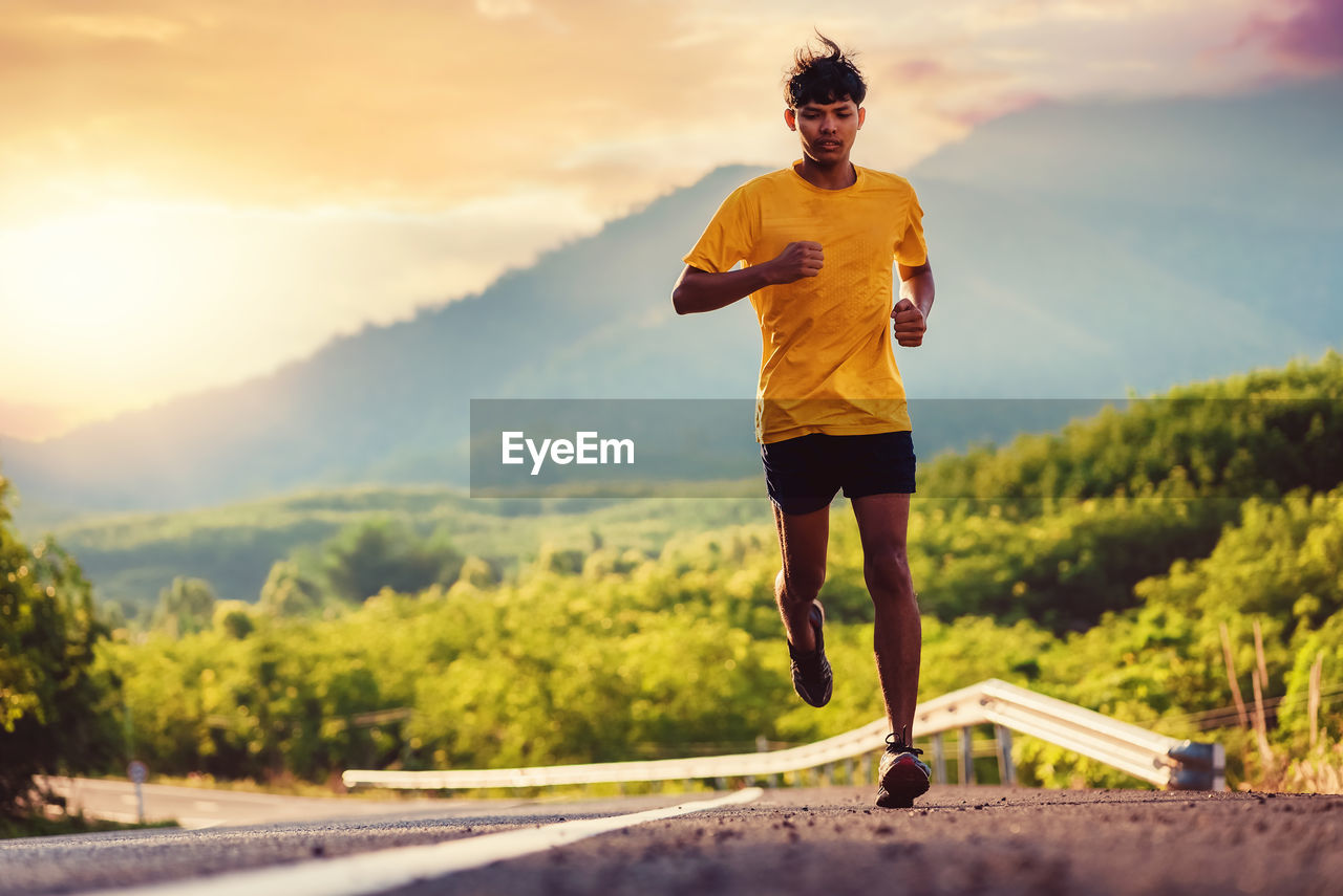 Athlete runner feet running on road, jogging concept at outdoors. man running for exercise.