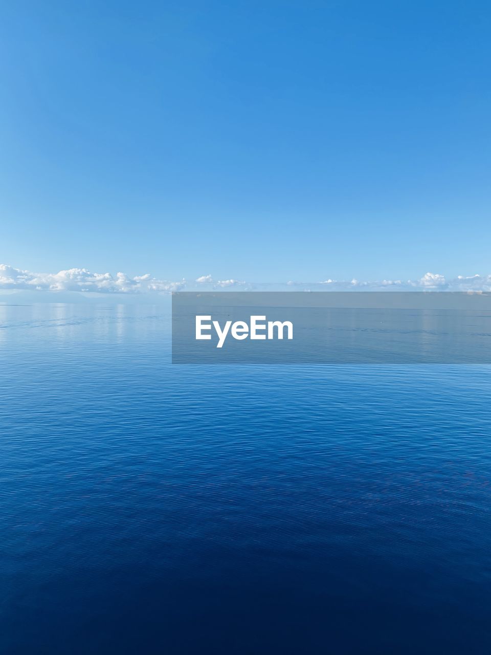 Scenic view of sea against blue sky