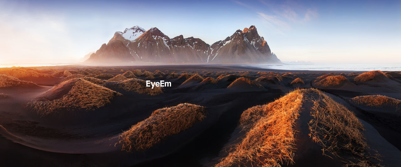 PANORAMIC SHOT OF SEA AND ROCKS AGAINST SKY