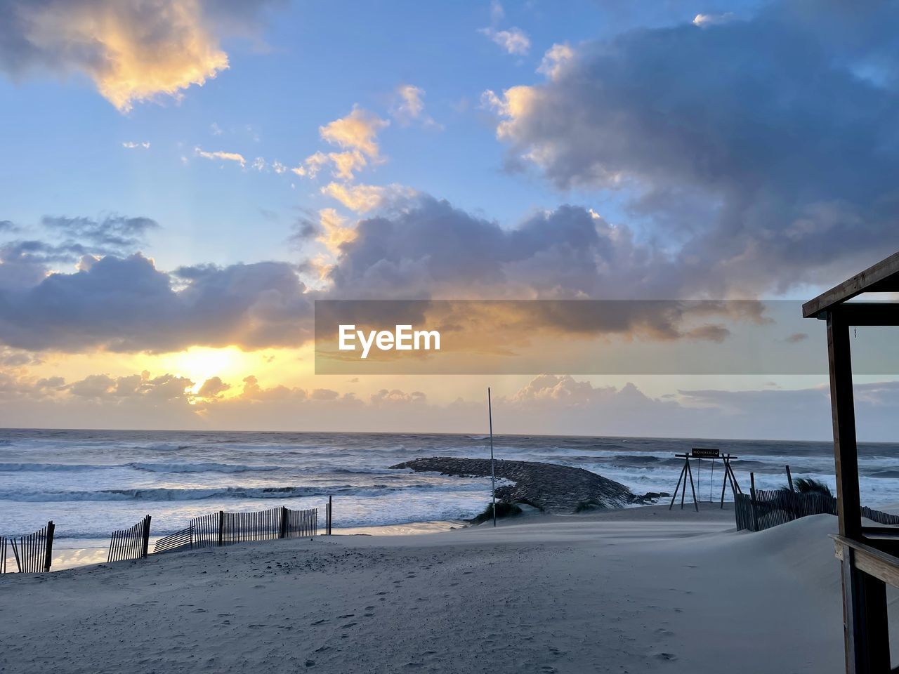 sky, sea, water, beach, ocean, land, cloud, sunset, scenics - nature, beauty in nature, shore, nature, horizon over water, coast, tranquility, wave, environment, horizon, travel destinations, travel, sand, holiday, vacation, tranquil scene, body of water, trip, seascape, architecture, landscape, sunlight, sun, tourism, pier, idyllic, outdoors, coastline, dusk, blue, summer, hut, dramatic sky, built structure, evening, no people, bay, motion, relaxation, wood, water's edge, urban skyline
