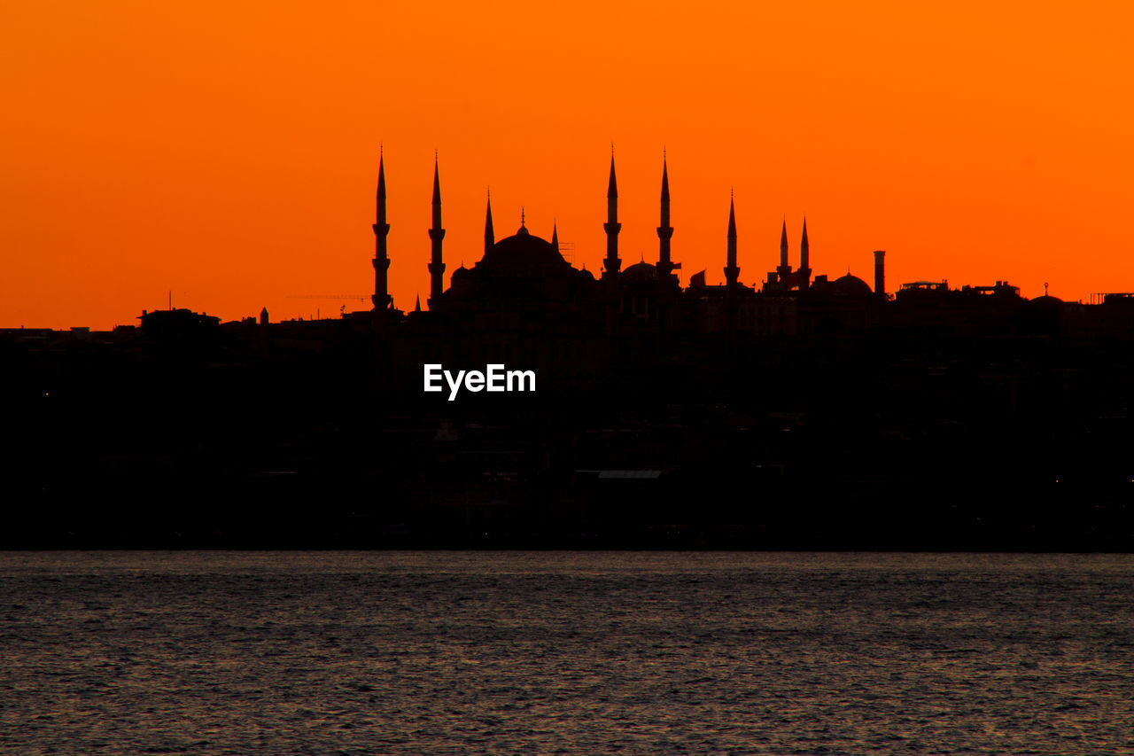 Silhouette of blue mosque in lake