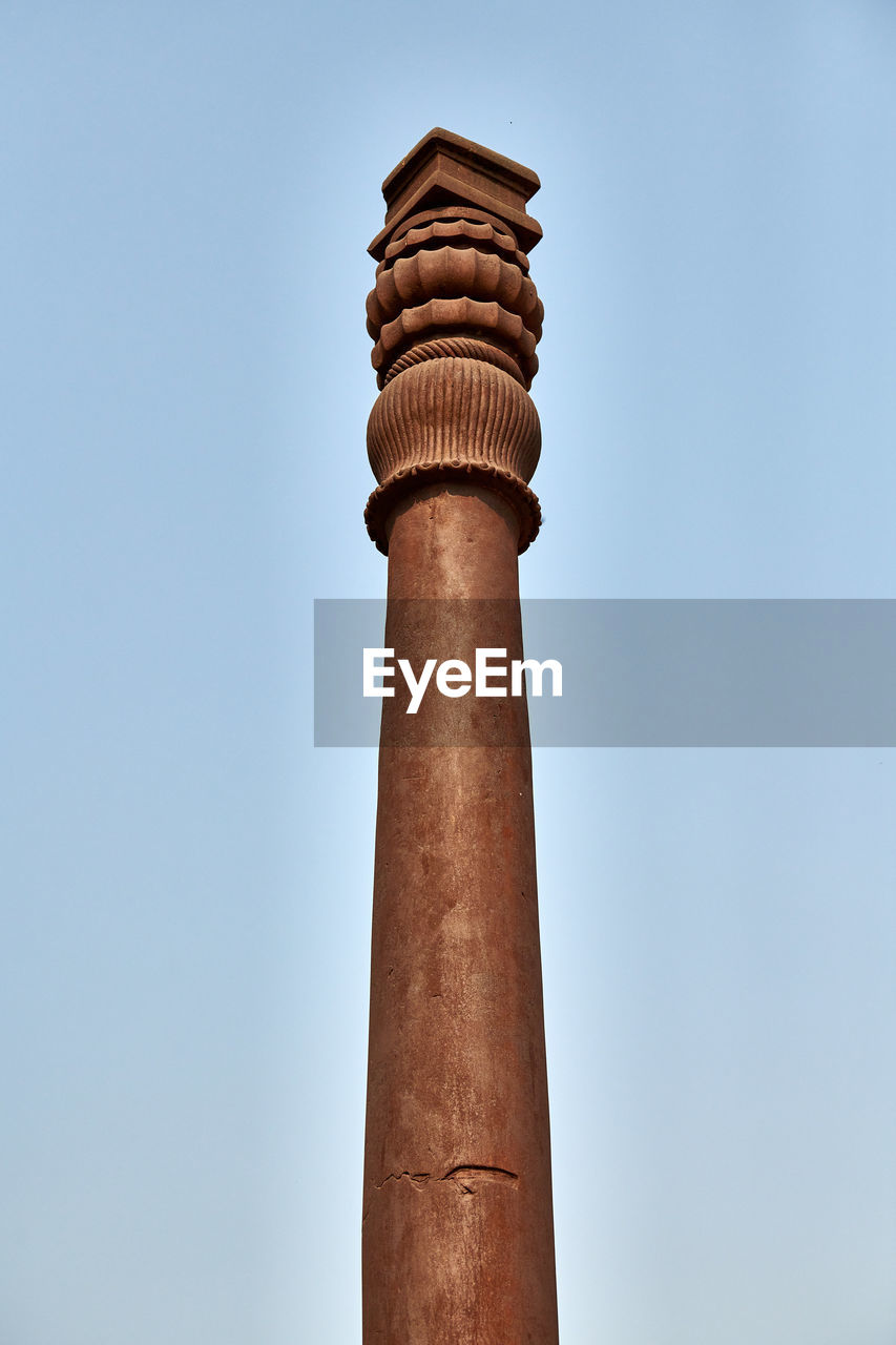 column, architecture, sky, built structure, tower, temple, architectural column, low angle view, no people, history, clear sky, the past, chimney, nature, building exterior, blue, travel destinations, day, wood, outdoors, sculpture, lighthouse, travel