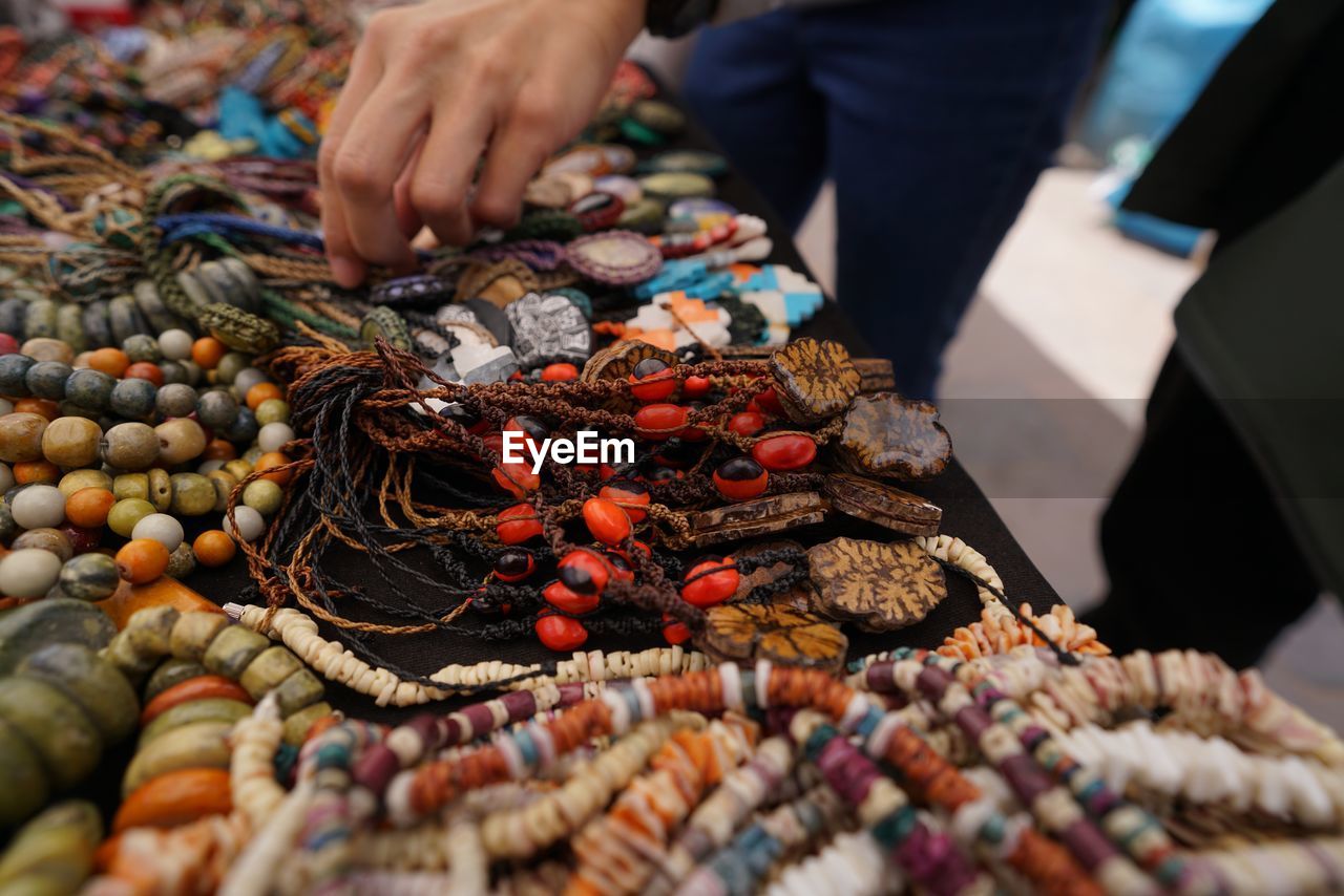 Midsection of person for sale at market stall