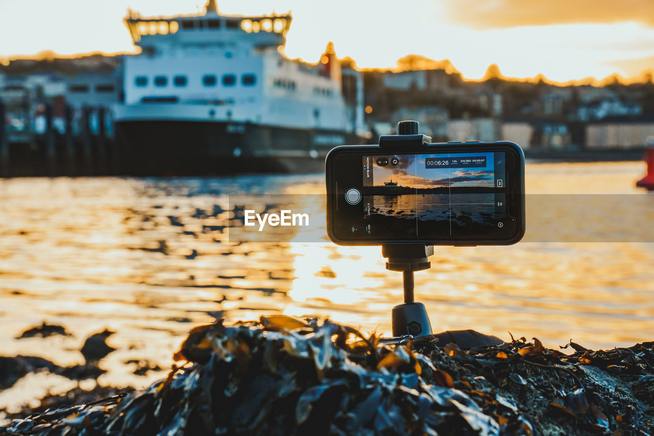 Smart phone photography setup capturing an island sunset
