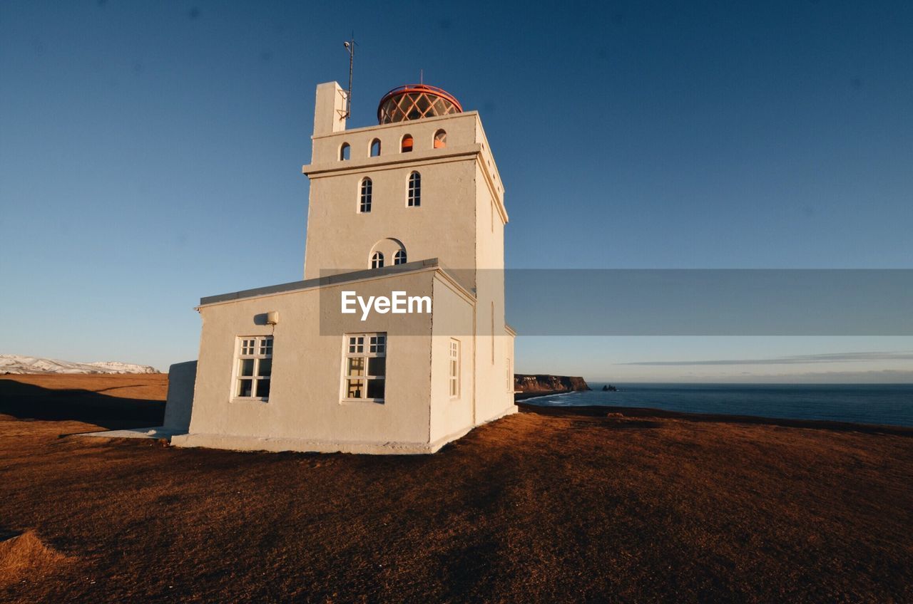 Lighthouse against clear blue sky