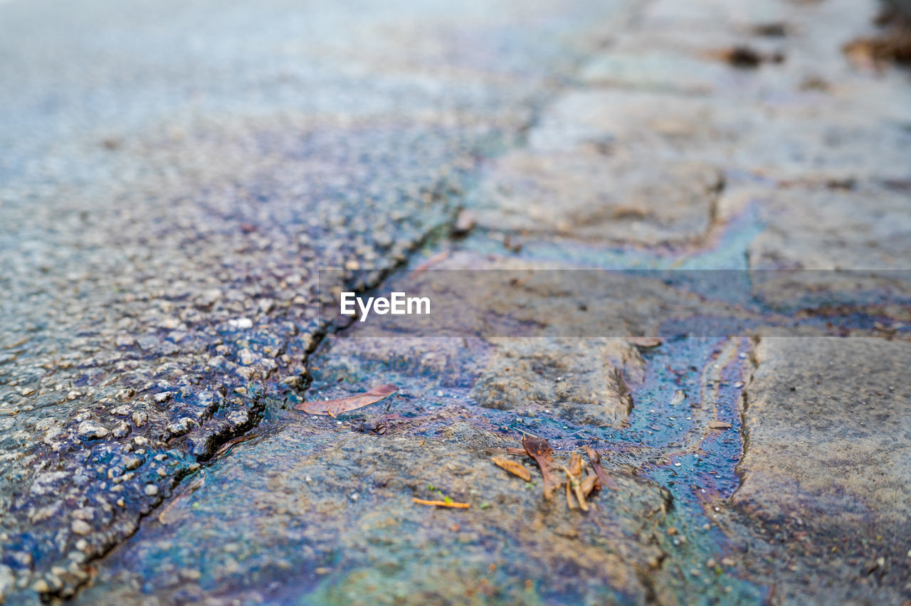 no people, close-up, textured, soil, blue, day, backgrounds, selective focus, rock, full frame, leaf, outdoors, nature, pattern, rough, water, high angle view, road, footpath, street, multi colored