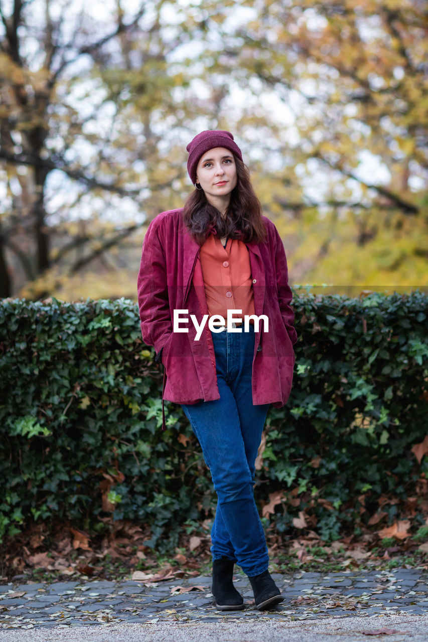 Portrait of girl in autumn nature foliage. full leight