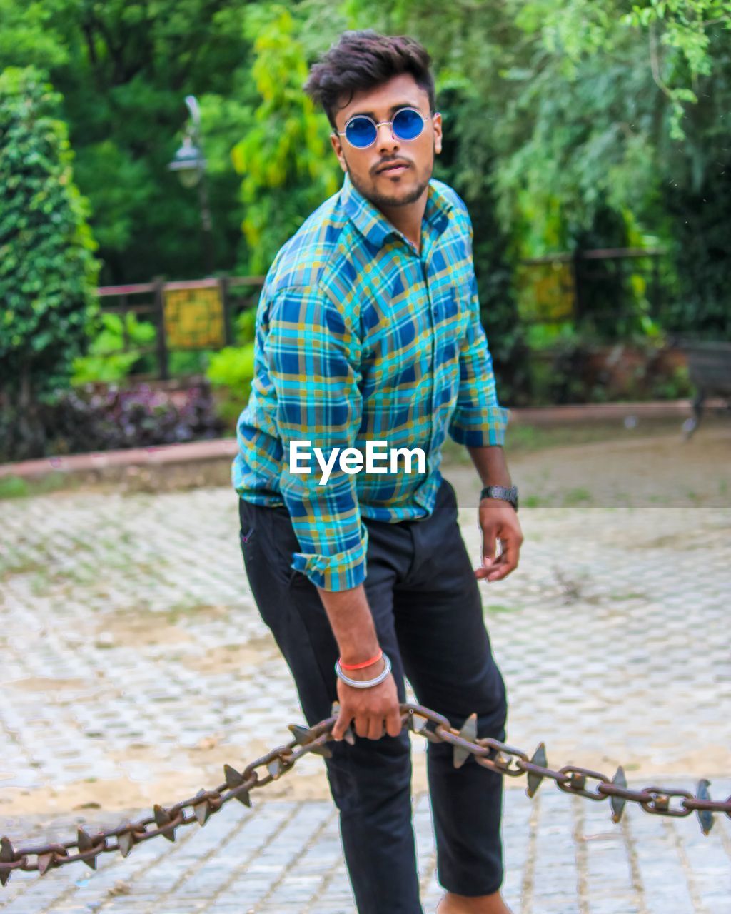 Portrait of young man wearing sunglasses standing outdoors