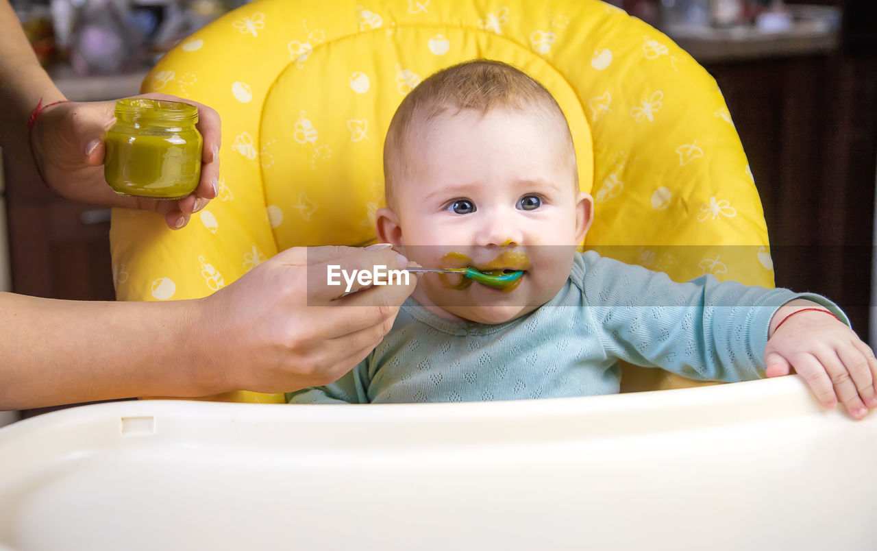 close-up of boy eating food in bathtub