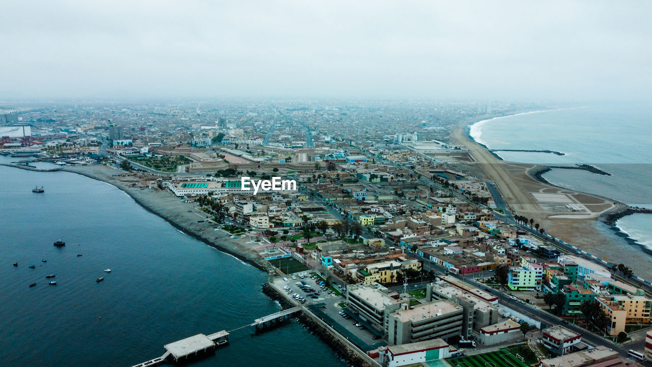 HIGH ANGLE VIEW OF BUILDINGS AGAINST SKY