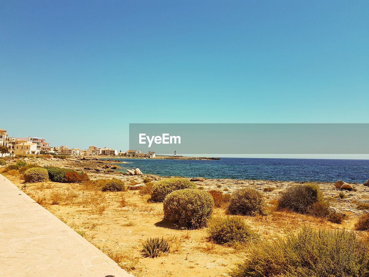 Scenic view of sea against clear blue sky